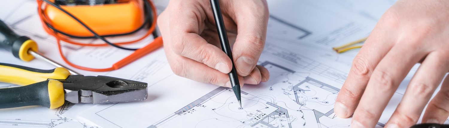 Close up view of electrical engineer drawing up plans