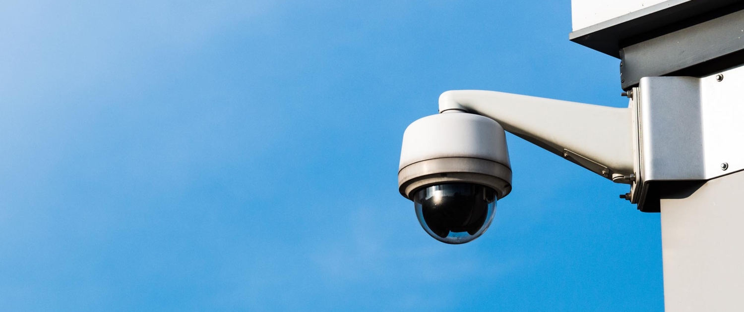 view of a CCTV camera attached to a building during the day
