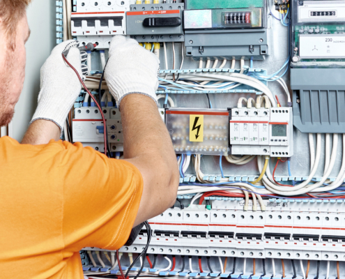 An electrical engineer checks the parameters of the electrical panel