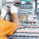 An electrical engineer checks the parameters of the electrical panel