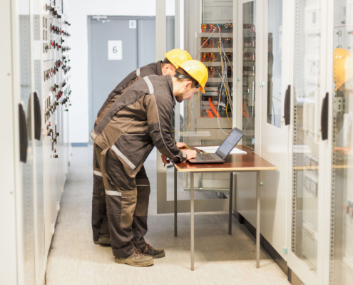 Two workers performing an electrical audit