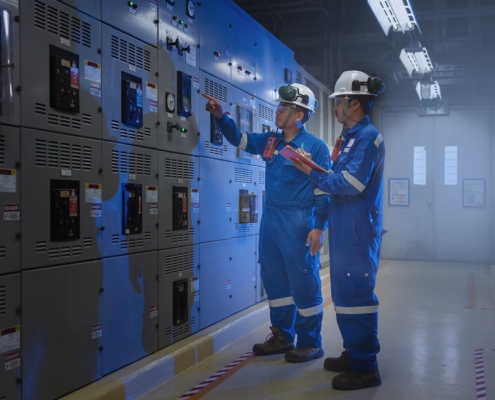 Electricians inspecting electrical system