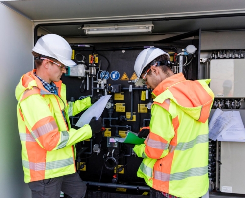 Professionals inspecting electrical system outside