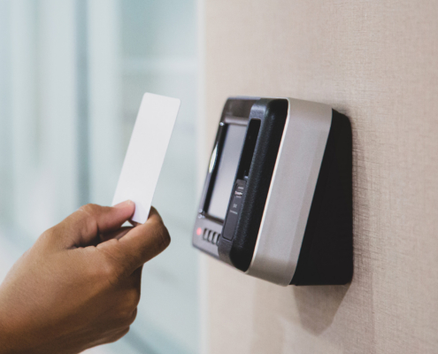 Proximity card door unlock, Hand security man using ID card on fingerprint scan reader
